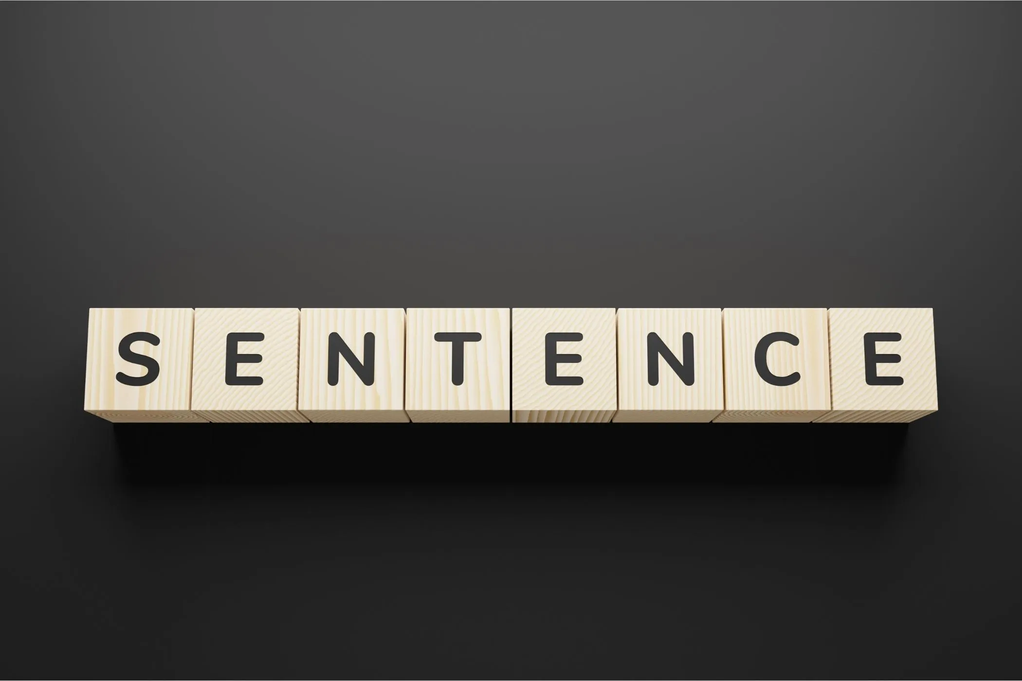 A photo of the word sentence in wooden blocks.